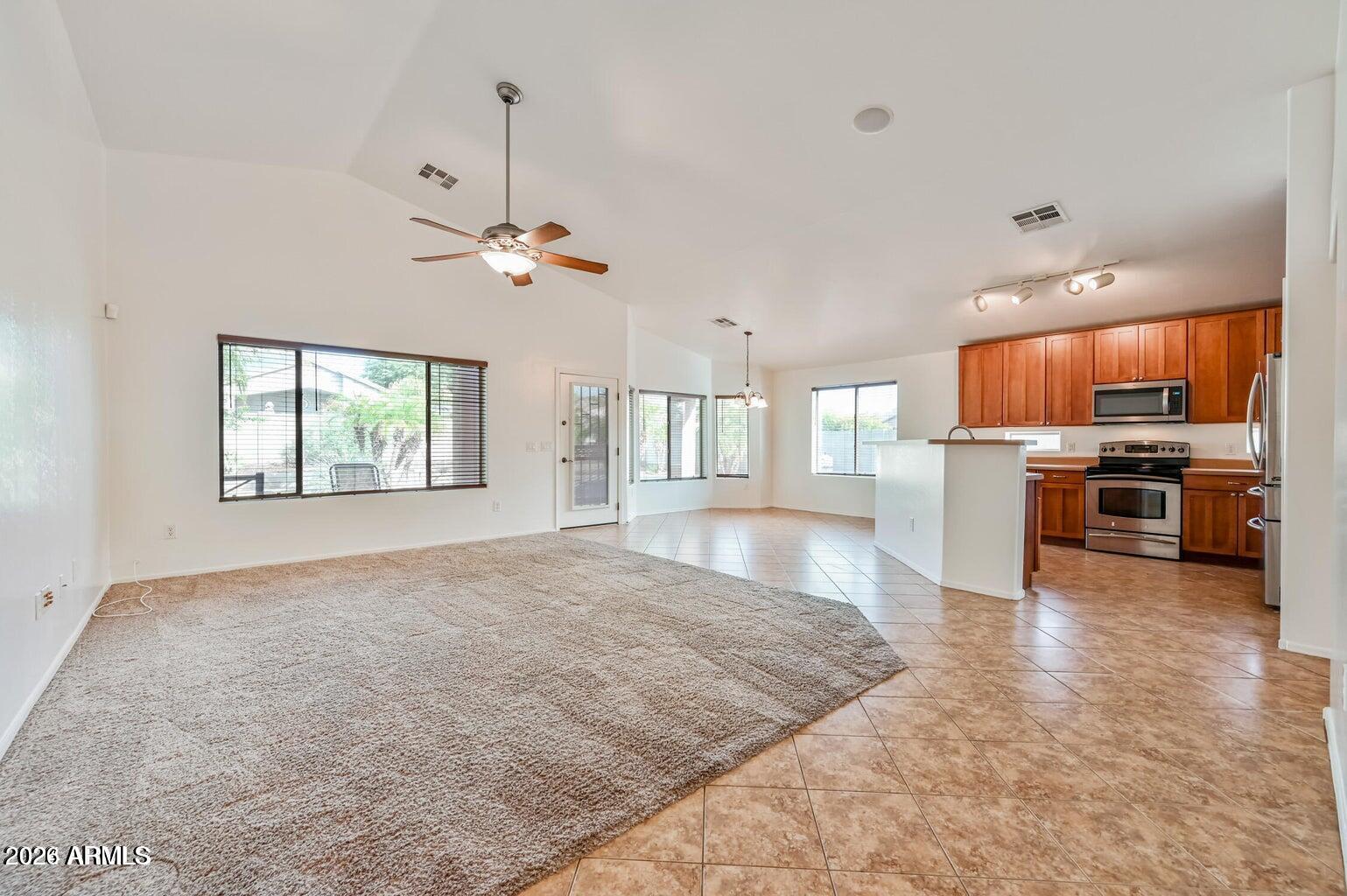 7809 South 20th Lane Phoenix, AZ 85041 - Photo 8 of 31 a large kitchen with cabinets and stainless steel appliances