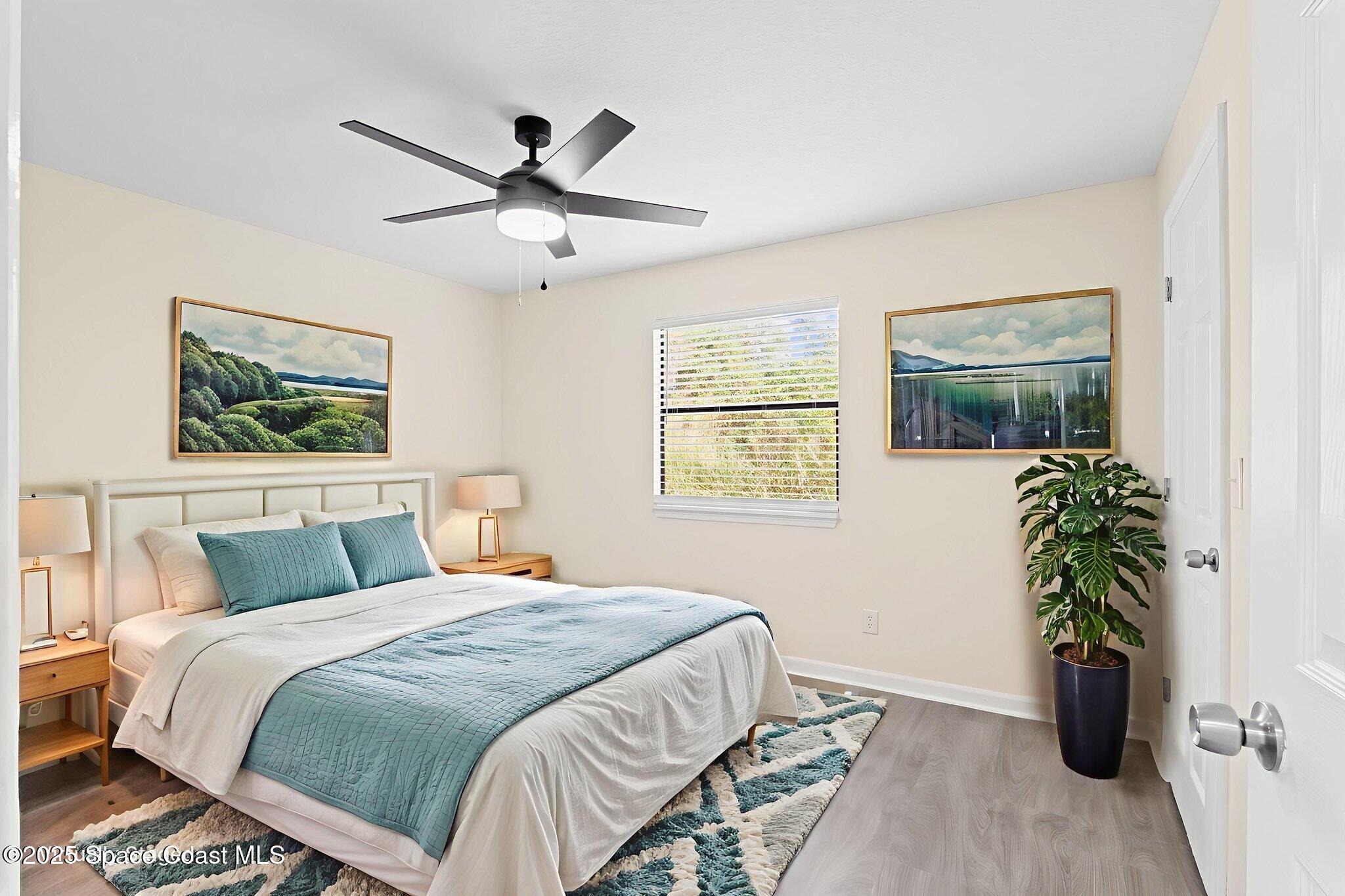1884 Agora Circle Southeast, Unit 101 Palm Bay, FL 32909 - Photo 12 of 18 a bedroom with a large bed and a potted plant