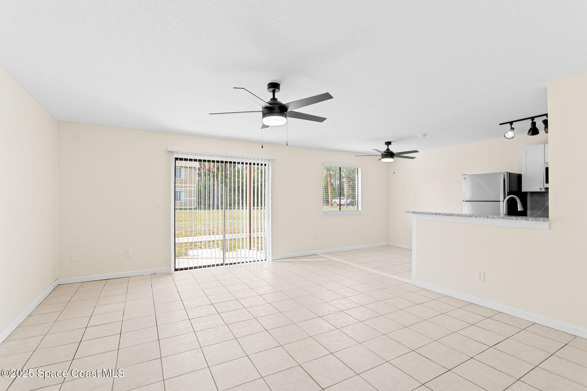 1884 Agora Circle Southeast, Unit 101 Palm Bay, FL 32909 - Photo 3 of 18 a view of an empty room with a window