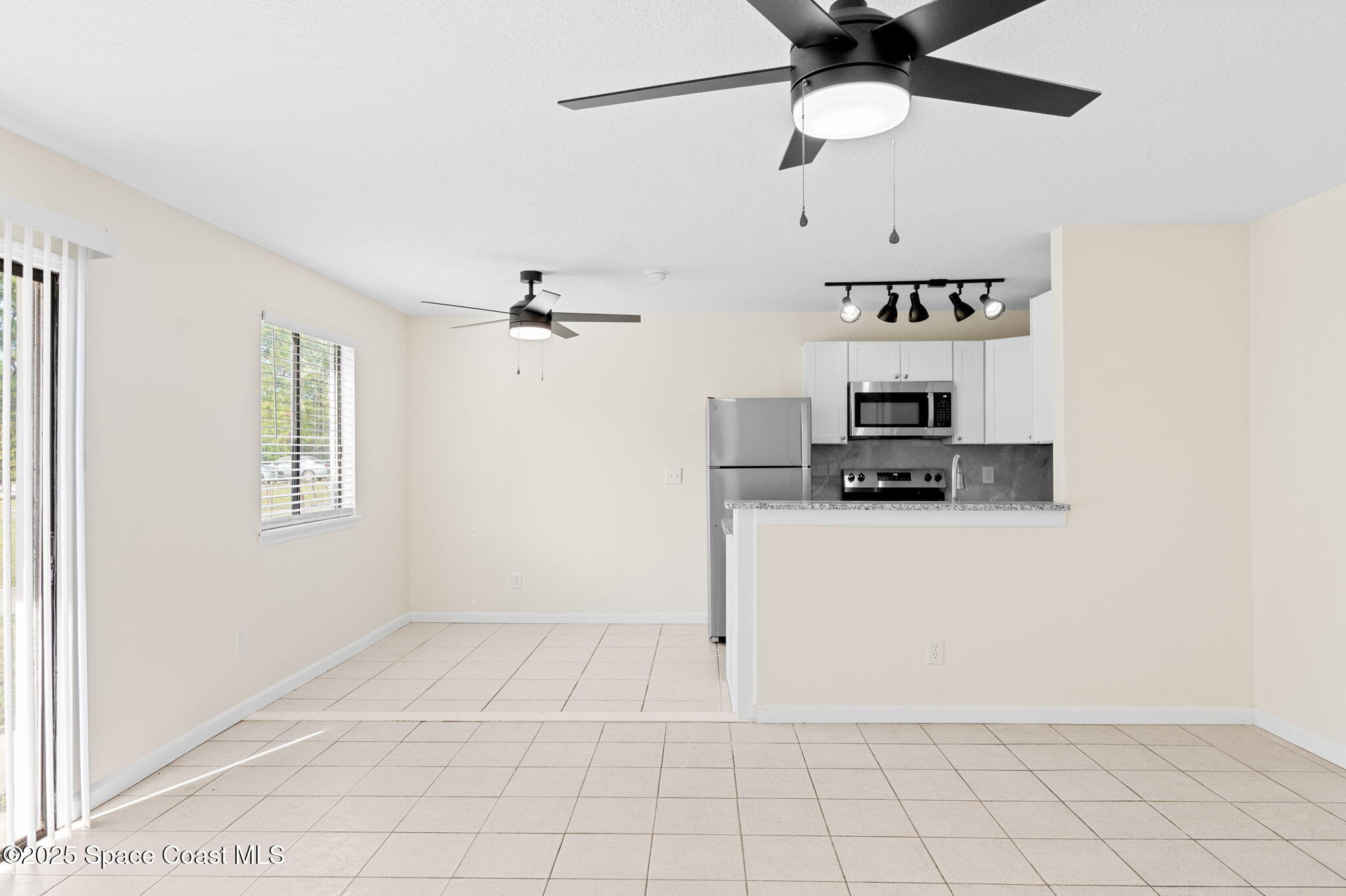 1884 Agora Circle Southeast, Unit 101 Palm Bay, FL 32909 - Photo 5 of 18 a view of kitchen with cabinets and window