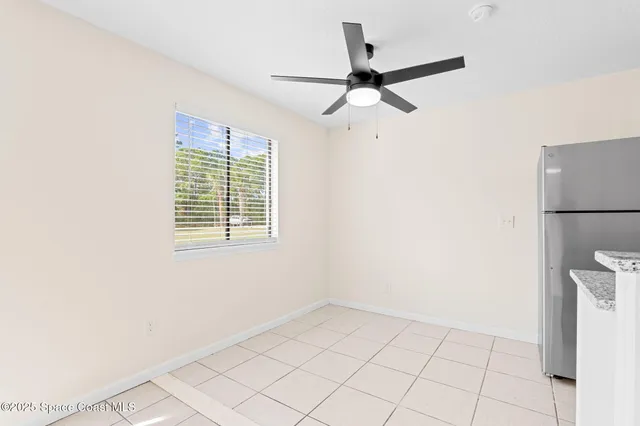 a view of a livingroom with a ceiling fan and window