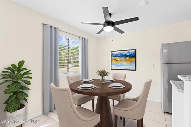 a view of a dining room with furniture and a potted plant
