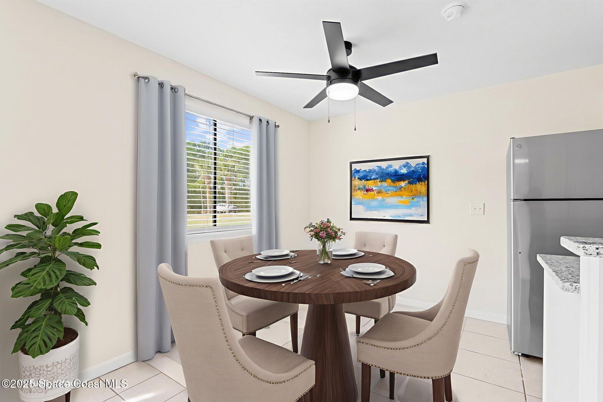 1884 Agora Circle Southeast, Unit 101 Palm Bay, FL 32909 - Photo 8 of 18 a view of a dining room with furniture and a potted plant