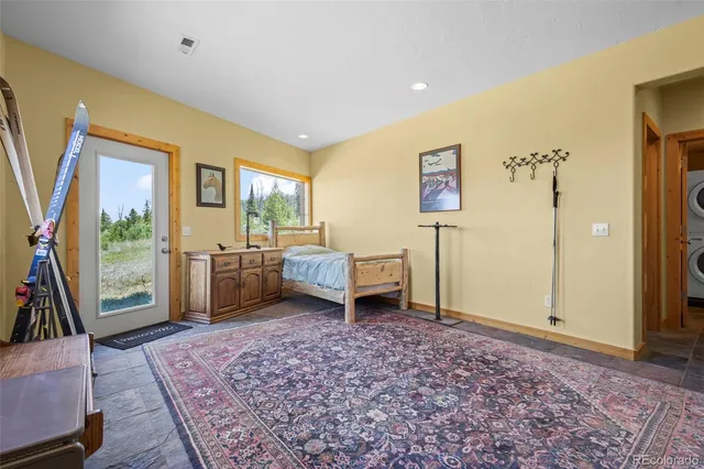 a spacious bedroom with a bed and a window