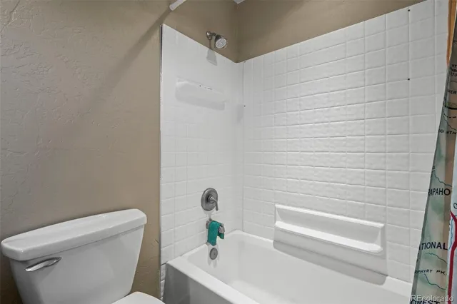 a bathroom with a toilet and a bathtub