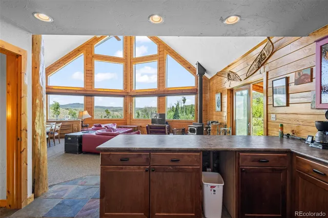 a kitchen with a large window and a sink