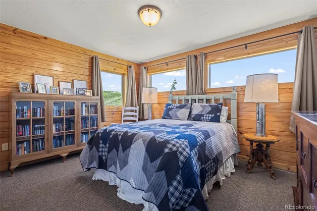 a bedroom with a large bed and a window