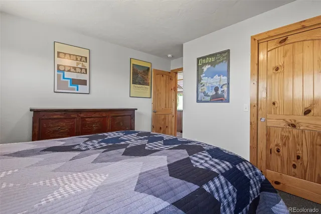 a bedroom with a large bed and a window