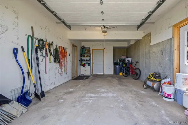 a view of a brick house with a yard and plants