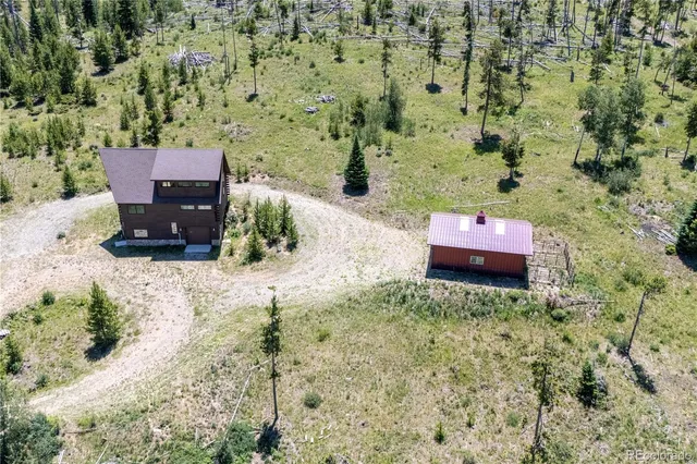 an aerial view of a house with a yard