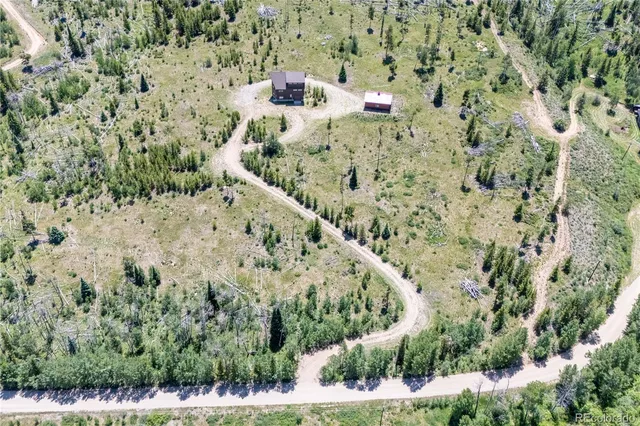 a view of a yard with a wooden wall