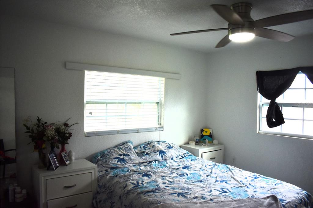 15355 Southwest 85th Avenue Dunnellon, FL 34432 - Photo 11 of 23 a bedroom with a bed and a potted plant