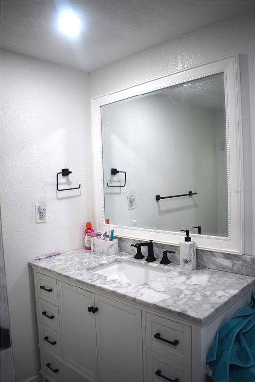 15355 Southwest 85th Avenue Dunnellon, FL 34432 - Photo 13 of 23 a bathroom with a granite countertop sink and a mirror