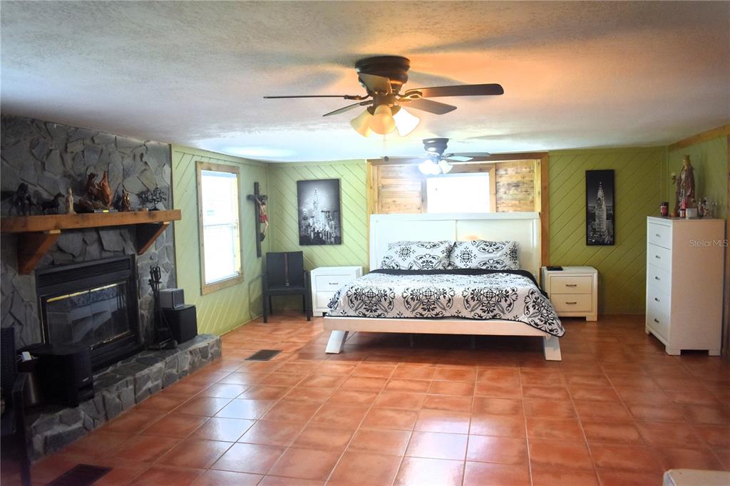 15355 Southwest 85th Avenue Dunnellon, FL 34432 - Photo 14 of 23 a bedroom with a bed and a fireplace
