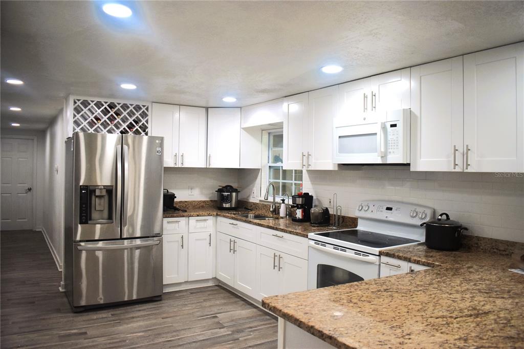 15355 Southwest 85th Avenue Dunnellon, FL 34432 - Photo 10 of 23 a kitchen with a refrigerator sink and cabinets