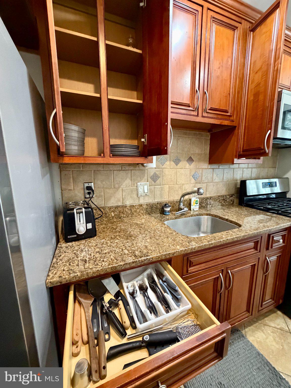 19 Hamilton Street Northeast, Unit 1 Washington, DC 20011 - Photo 10 of 17 Sleek kitchen with rich wood accents.