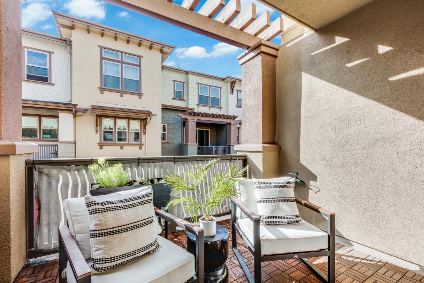 309 Marquetta Circle Mountain View, CA 94043 - Photo 12 of 34 a view of a patio with couches chairs and potted plants with wooden floor