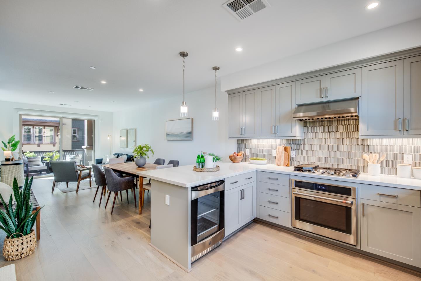 309 Marquetta Circle Mountain View, CA 94043 - Photo 5 of 34 a kitchen with a stove top oven a sink a dining table and chairs