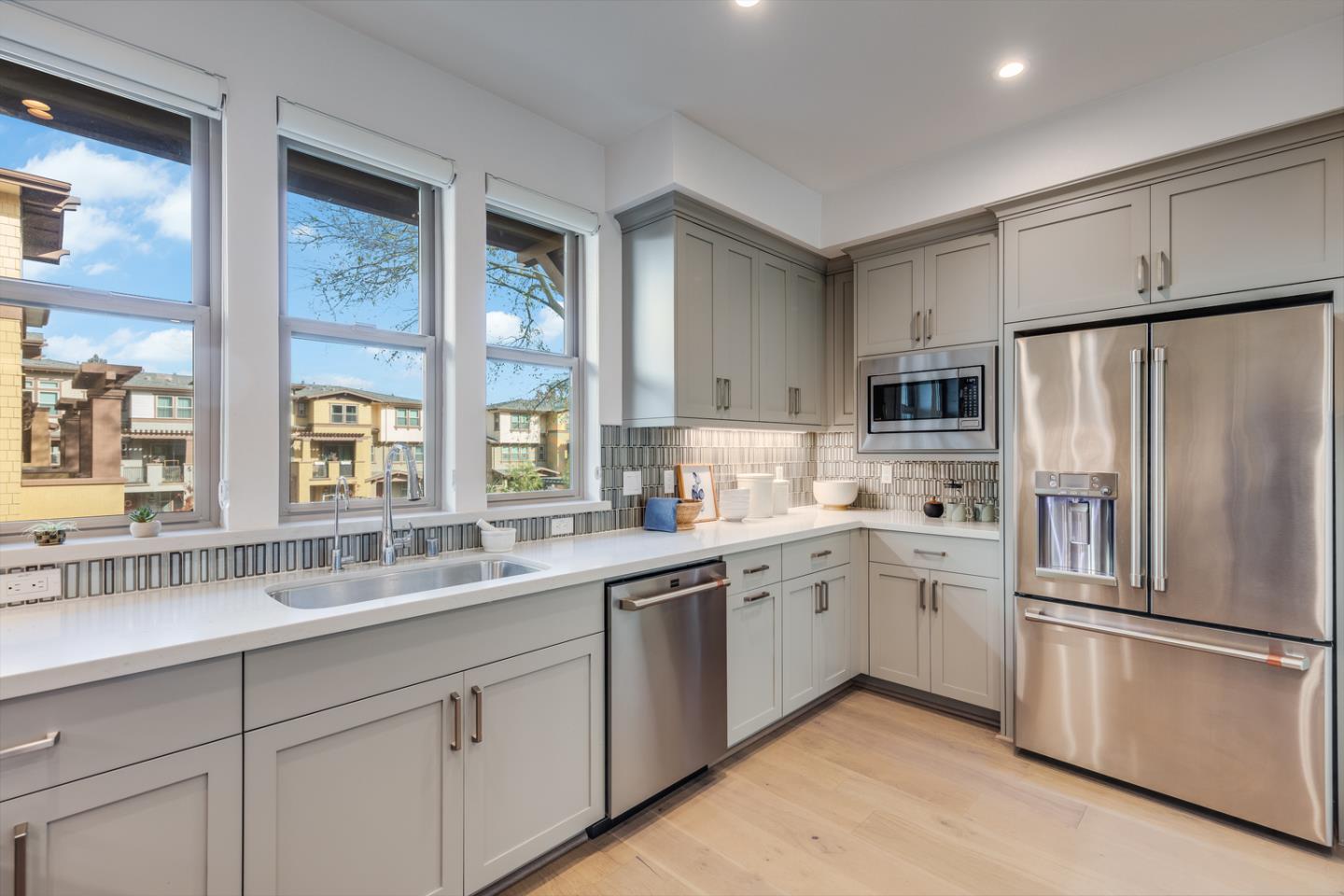 309 Marquetta Circle Mountain View, CA 94043 - Photo 7 of 34 a kitchen with white cabinets and white appliances