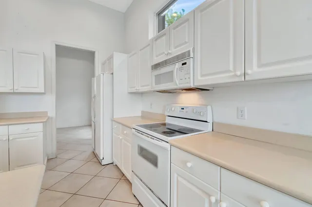 an aerial view of residential houses with outdoor space and street view