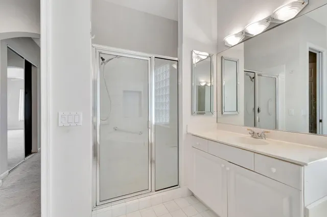 an aerial view of a house with outdoor space lake view and a garden