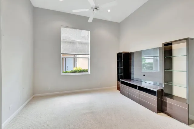 an aerial view of a house with outdoor space lake view and a garden