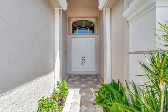 a view of a hallway with wooden floor and a bathroom