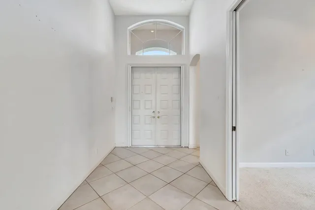 an empty room with windows and entrance