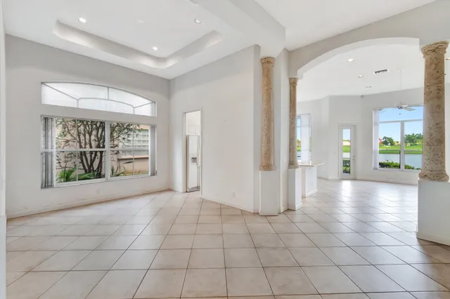 a view of kitchen with stainless steel appliances granite countertop a sink and a window