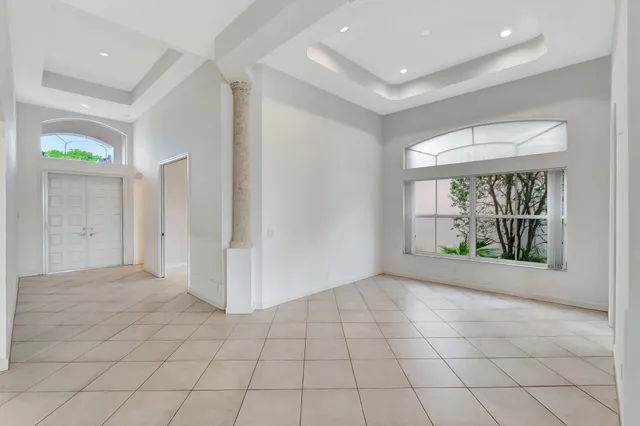 a kitchen with a sink window and cabinets