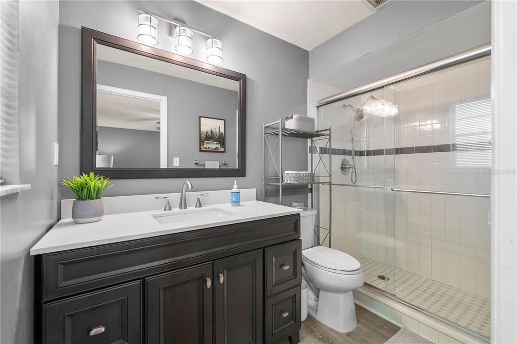 1960 Union Street, Unit 28 Clearwater, FL 33763 - Photo 11 of 23 a bathroom with a sink toilet a mirror and shower