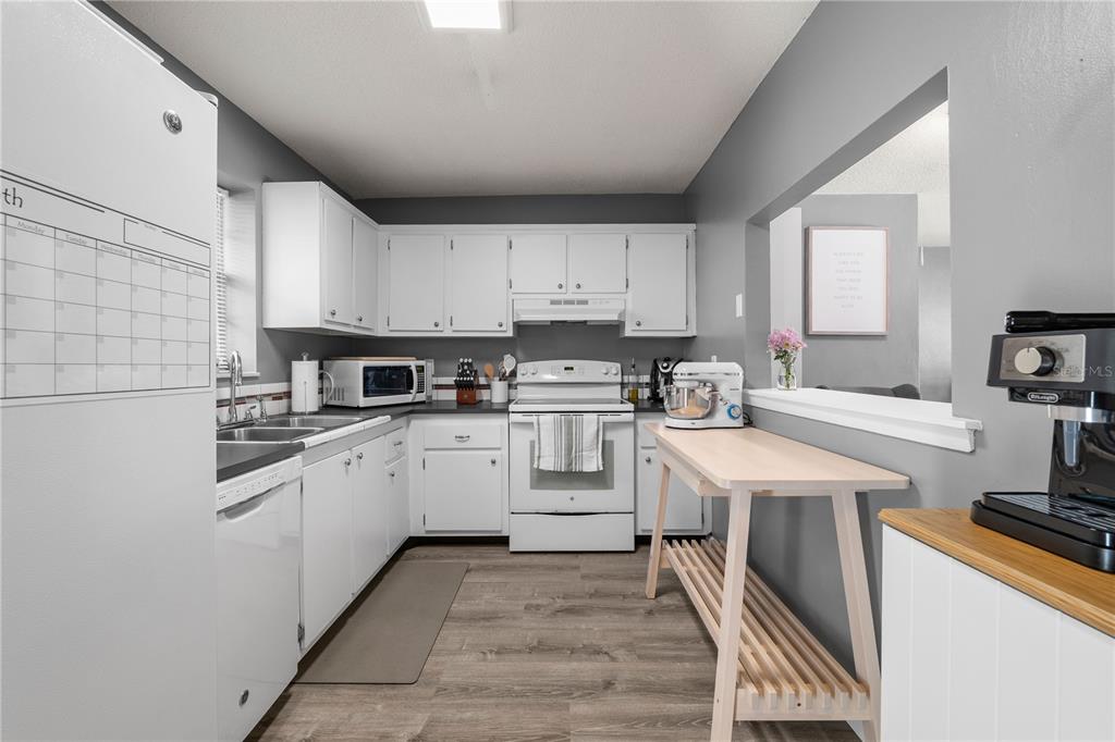 1960 Union Street, Unit 28 Clearwater, FL 33763 - Photo 6 of 23 a kitchen with granite countertop a sink appliances cabinets and counter space