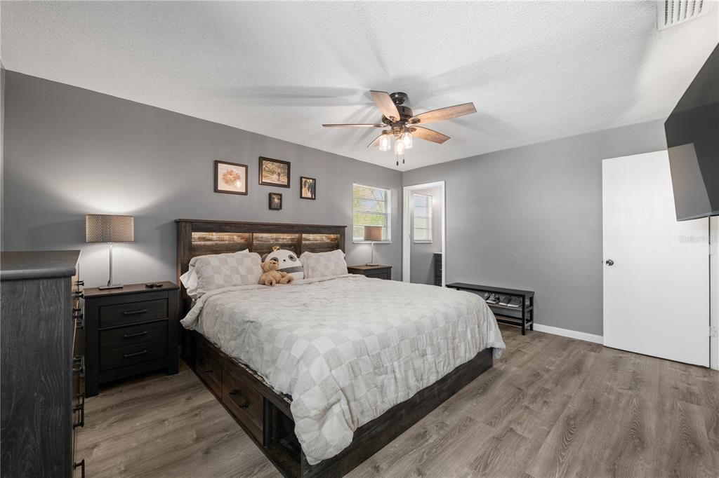 1960 Union Street, Unit 28 Clearwater, FL 33763 - Photo 9 of 23 a bedroom with a bed and a chandelier