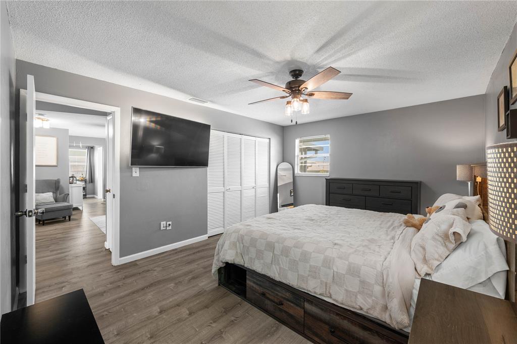 1960 Union Street, Unit 28 Clearwater, FL 33763 - Photo 10 of 23 a spacious bedroom with a bed and a flat screen tv