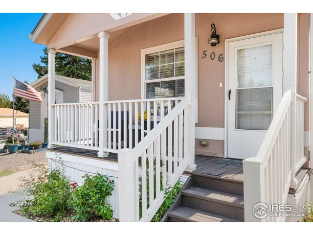 a view of a house with wooden floor fence and a porch