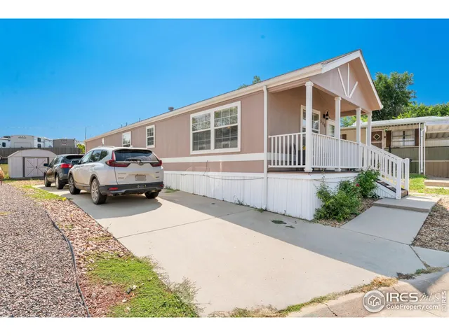 a couple of cars parked in front of a house
