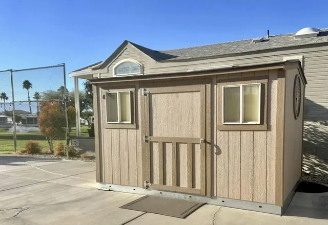 a view of a brick house with large windows
