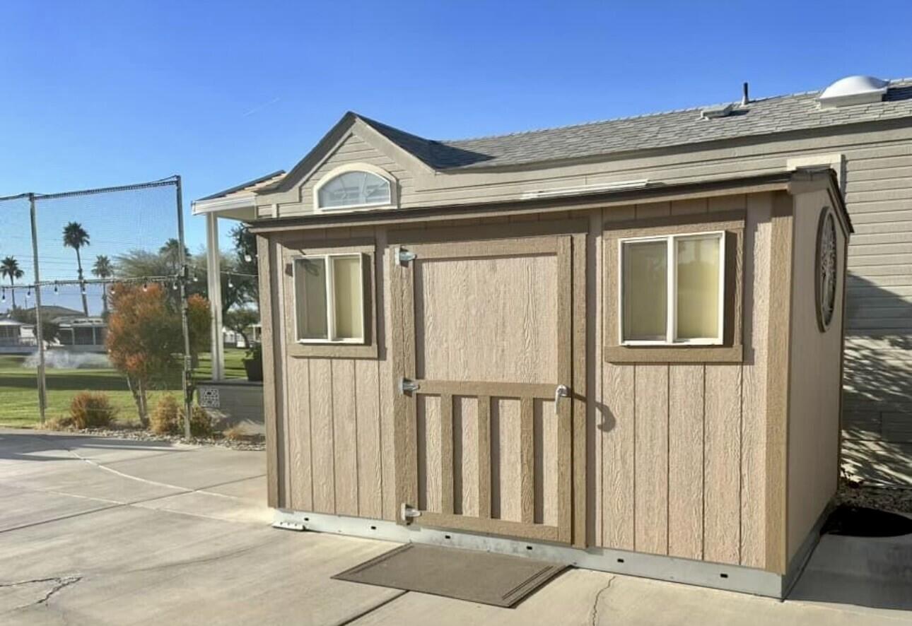 84136 Ave 44, Unit 277 Indio, CA 92203 - Photo 5 of 6 a view of a brick house with large windows