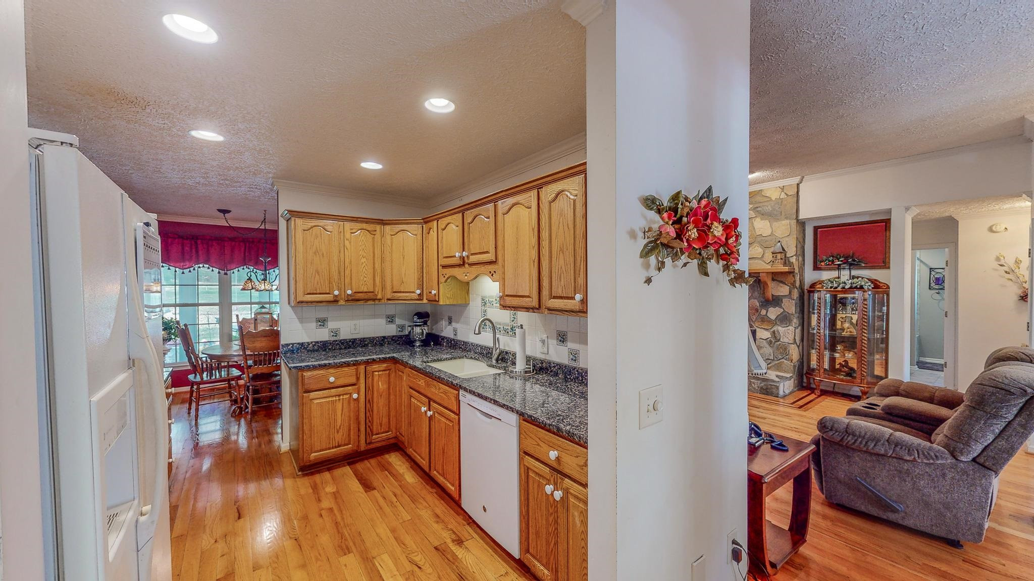 17 Richland Road Roxboro, NC 27574 - Photo 25 of 63 a kitchen with granite countertop a sink stove and refrigerator