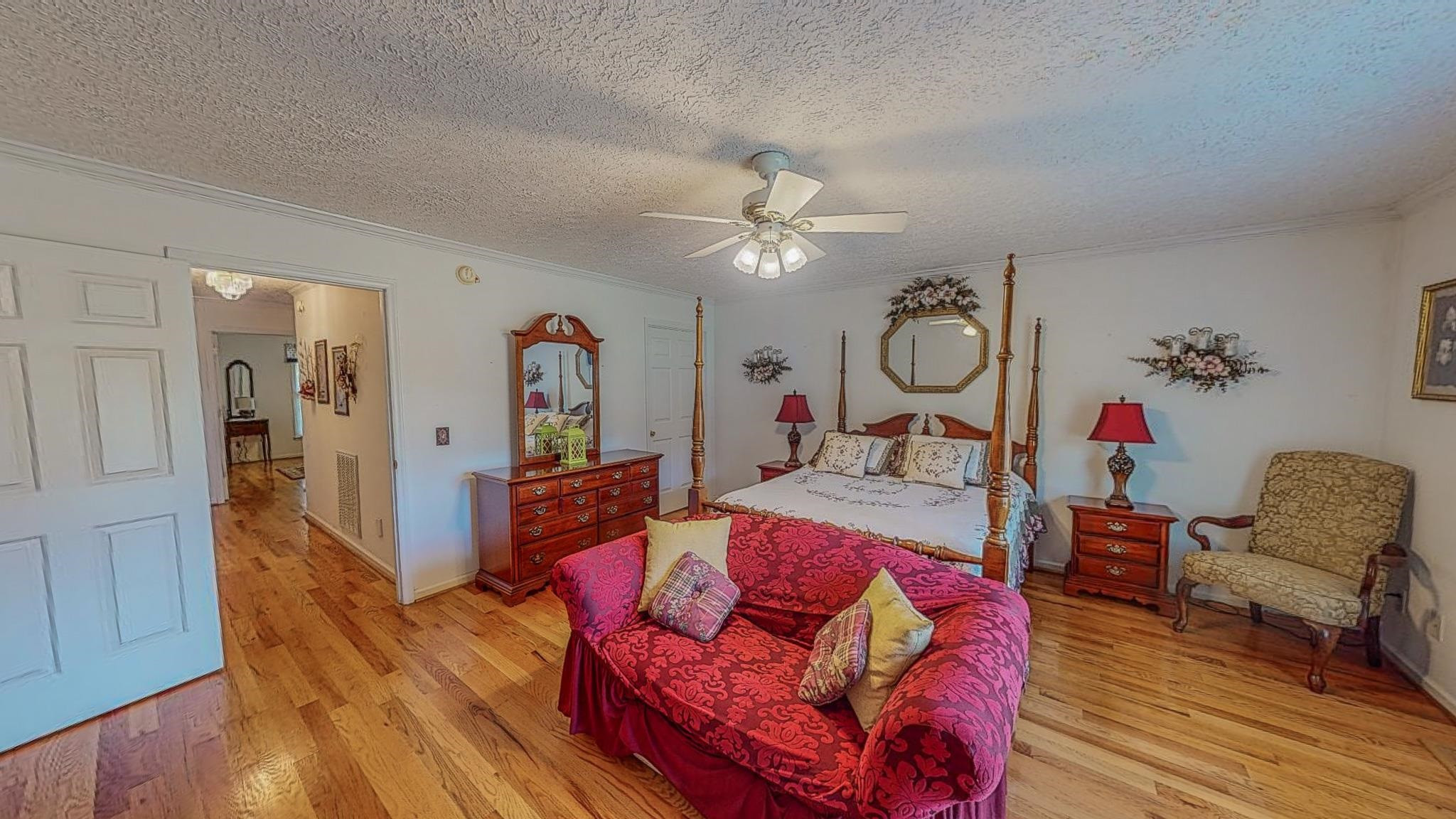 17 Richland Road Roxboro, NC 27574 - Photo 29 of 63 a living room with furniture chandelier and a wooden floor
