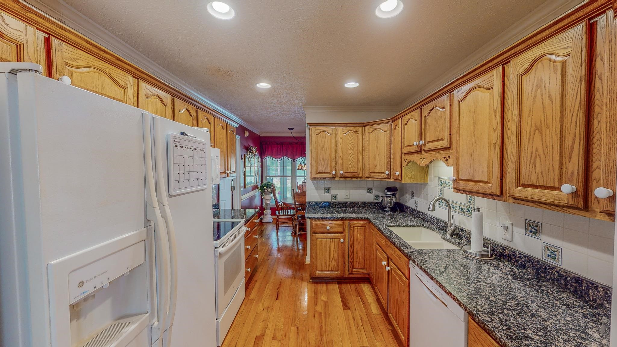 17 Richland Road Roxboro, NC 27574 - Photo 10 of 63 a kitchen with stainless steel appliances granite countertop a refrigerator a sink and wooden cabinets