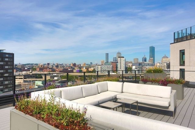 a view of a balcony with wooden floor and city view