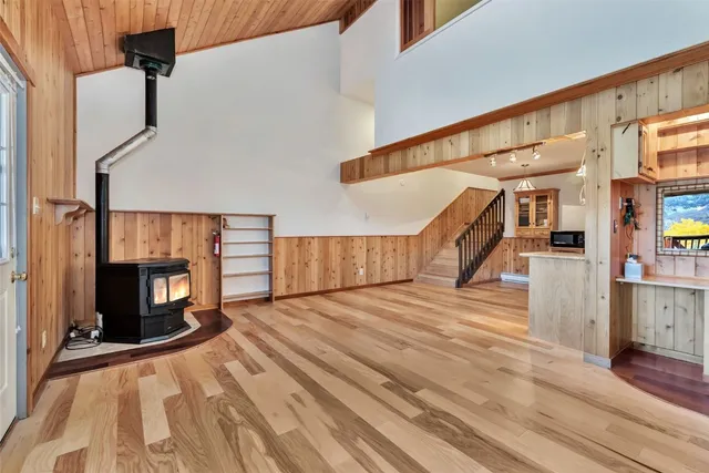 a view of a living room with stairs and a fireplace