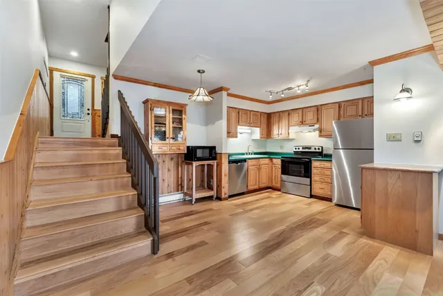 a kitchen with stainless steel appliances granite countertop a stove a sink and a microwave