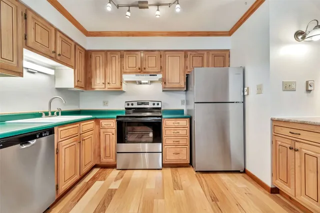 a kitchen with refrigerator and cabinets