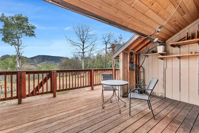 a view of balcony with wooden floor and fence