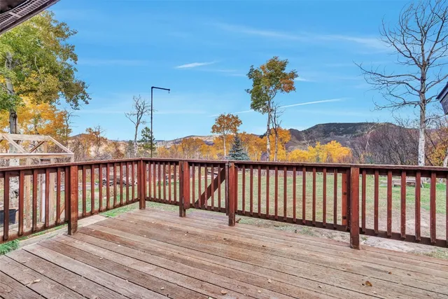 a view of a backyard with table and chairs with wooden fence