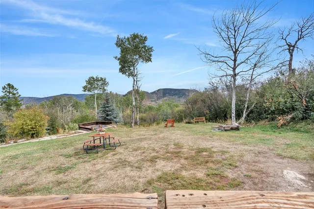 a view of a house with a yard chairs and a table