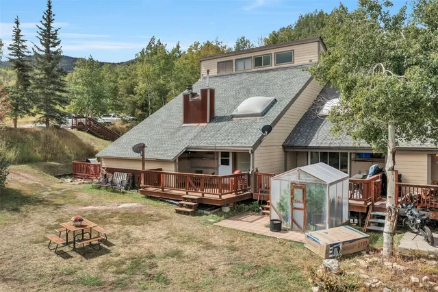 an aerial view of a house with a yard patio and fire pit