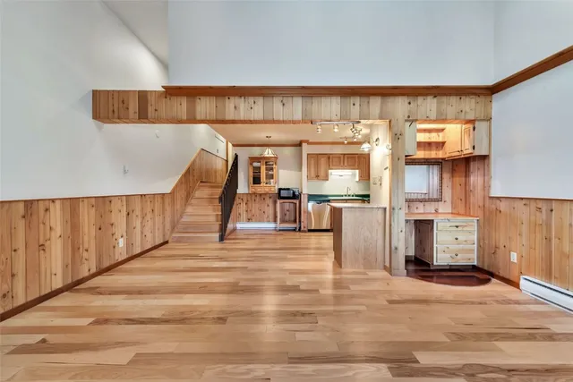 a view of staircase with railing and a window